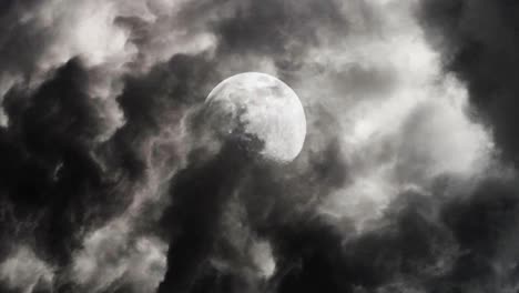 the moon at night covered in dark clouds