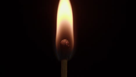 Close-Up-of-a-Lit-Match-Burning-in-the-Dark
