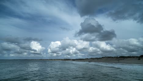 timelapse of clouds moving away from the viewer from sea to land over a beach