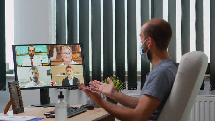 Business man with mask talking on video call