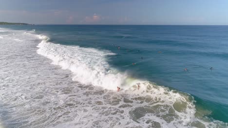 aerial shot of two surfers surfing a tube barrel wave in zicatela beach puerto escondido, oaxaca