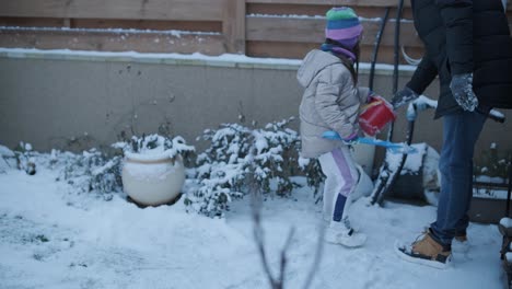 grandfather and granddaughter having fun in the snow