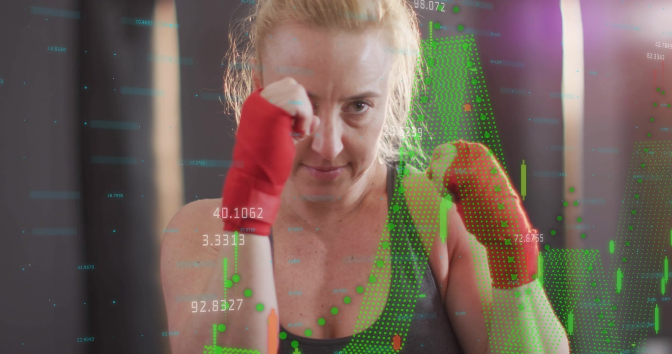 Vertical video: Reacting to HUD, woman in sports bra training with guarded jabs at gym, red wraps