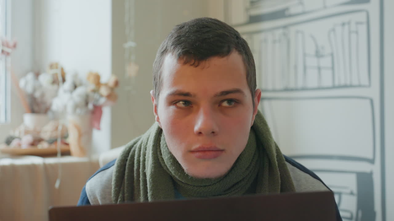 White male facing laptop camera intensely, closeup portrait with scarf and soft lights, direct gaze into lens, emotional vulnerability, vlog and livestream vibe, candid expression, intimate studio