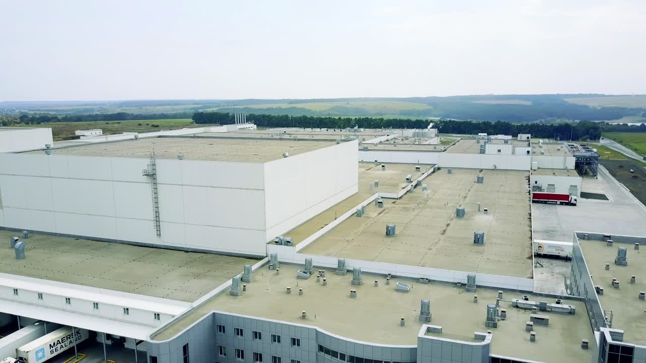 Industrial Building Exterior. Facade of an industrial building and warehouse with freight cars in length