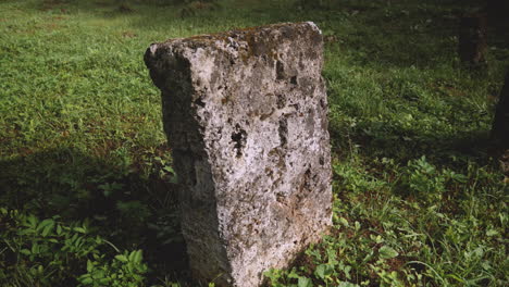 an old ancient tombstones of a christian grave, cinematic closeup panning view