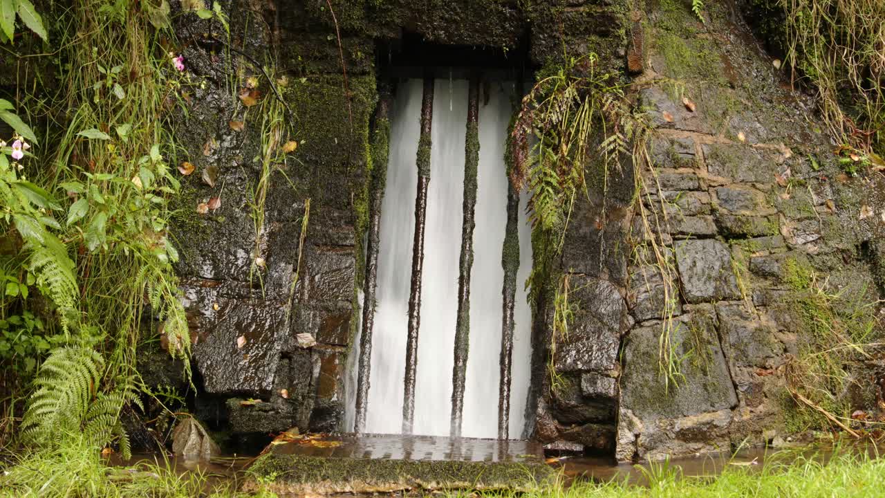 Close up of Rainwater being funnelled Behind bars controlled under the platform at Cynonville Station