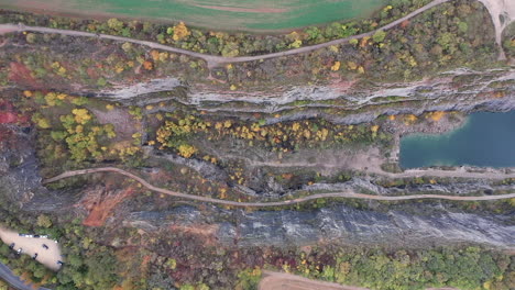 aerial view of deep abandoned flooded limestone quarry in a countryside of czech republic