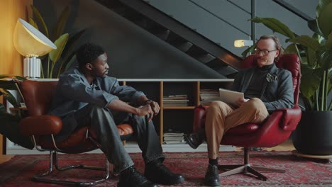 african american man having therapy session with psychologist in the office
