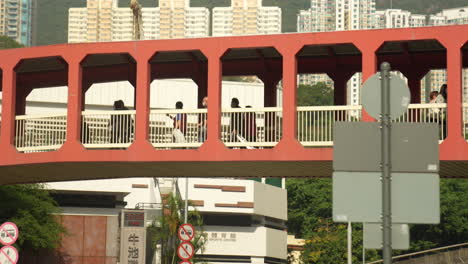 footbridge flow: unrecognisable people walking in hong kong