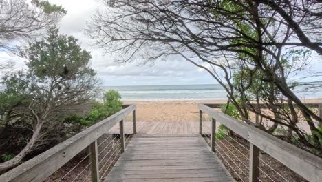 wooden path leading to a serene beach