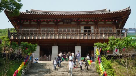 Korean-People-Walking-Through-Entrance-of-Cheonggyesa-Temple-On-Buddha's-Day-Celebration,-South-Korea-zoom-out-timelapse