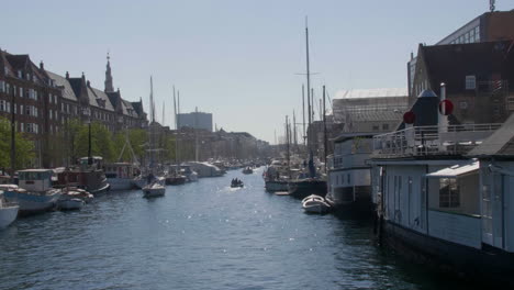 christianshavn canal scene with boats and copenhagen architecture