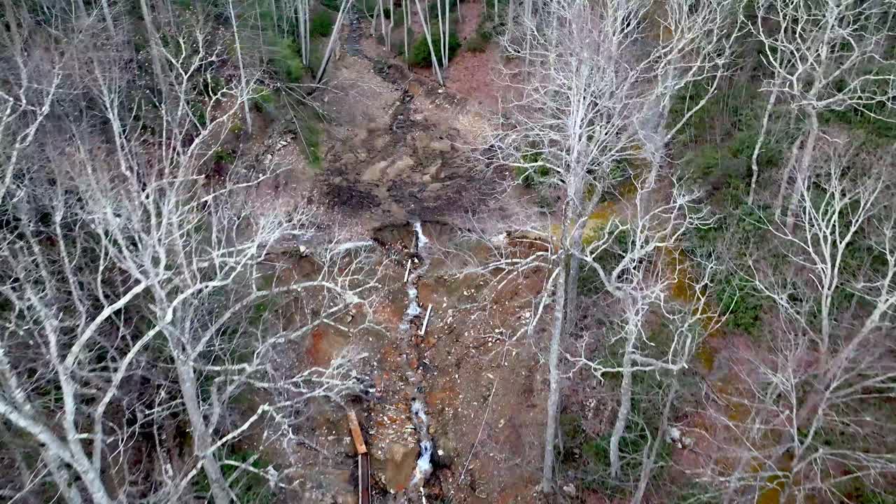earthen dam break and debris from flooding during hurricane helene near boone nc