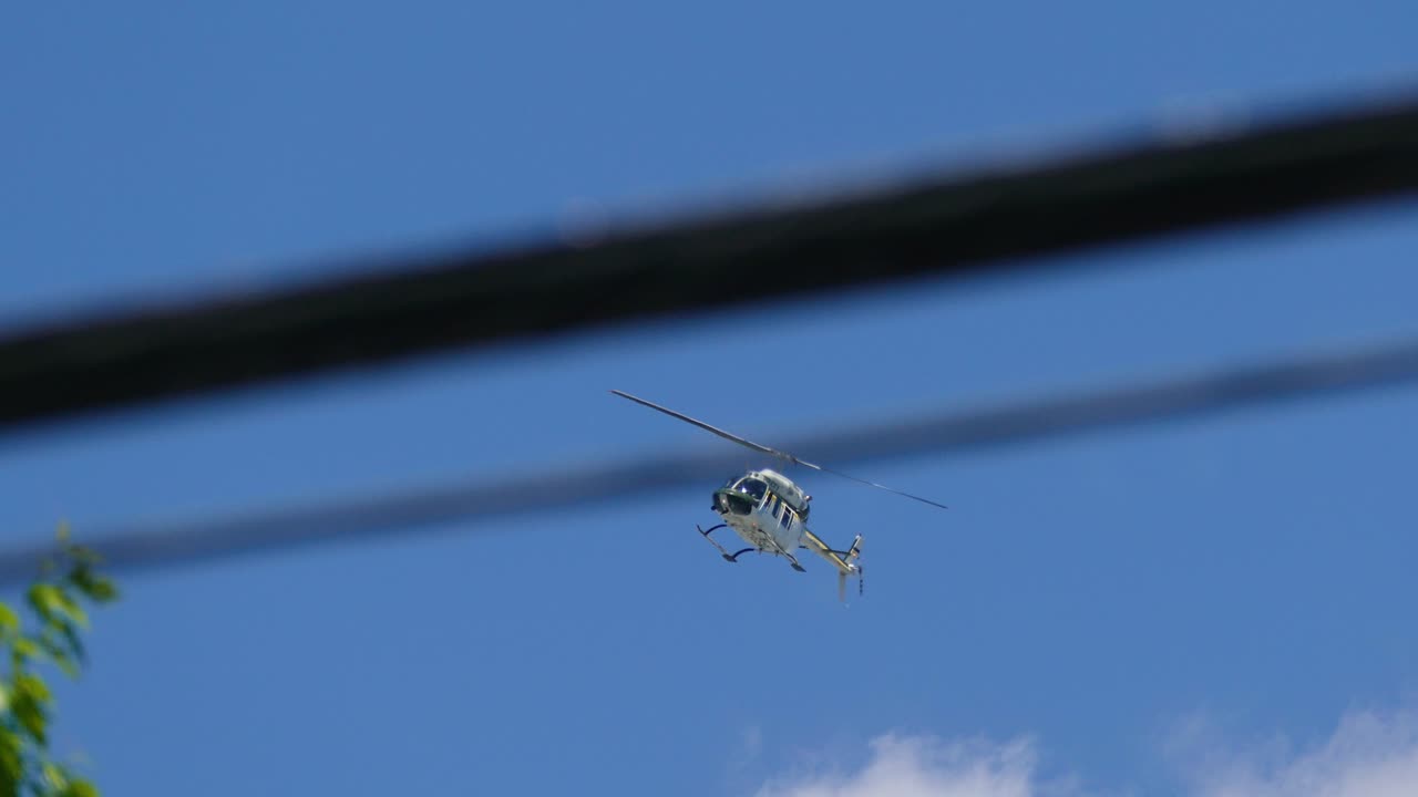 Helicopter hovering over the activists marching in the streets of Qu&eacute;bec City, who are protesting against the G7 Summit held in Qu&eacute;bec, Canada