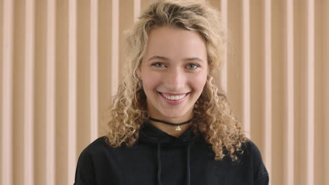 close-up-portrait-of-cute-young-blonde-woman-laughing-happy-looking-at-camera-independent-caucasian-female-wearing-black-hoodie