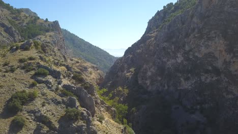 Aerial-revealing-shot-of-big-rocky-mountains-in-the-south-of-Spain-on-a-summer-day