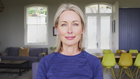 Portrait-of-caucasian-senior-woman-smiling-in-the-living-room-at-home