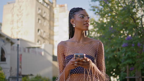 joyful girl browsing smartphone at summer street closeup.   woman