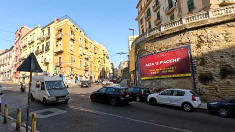 vehicles and pedestrians in a bustling naples street