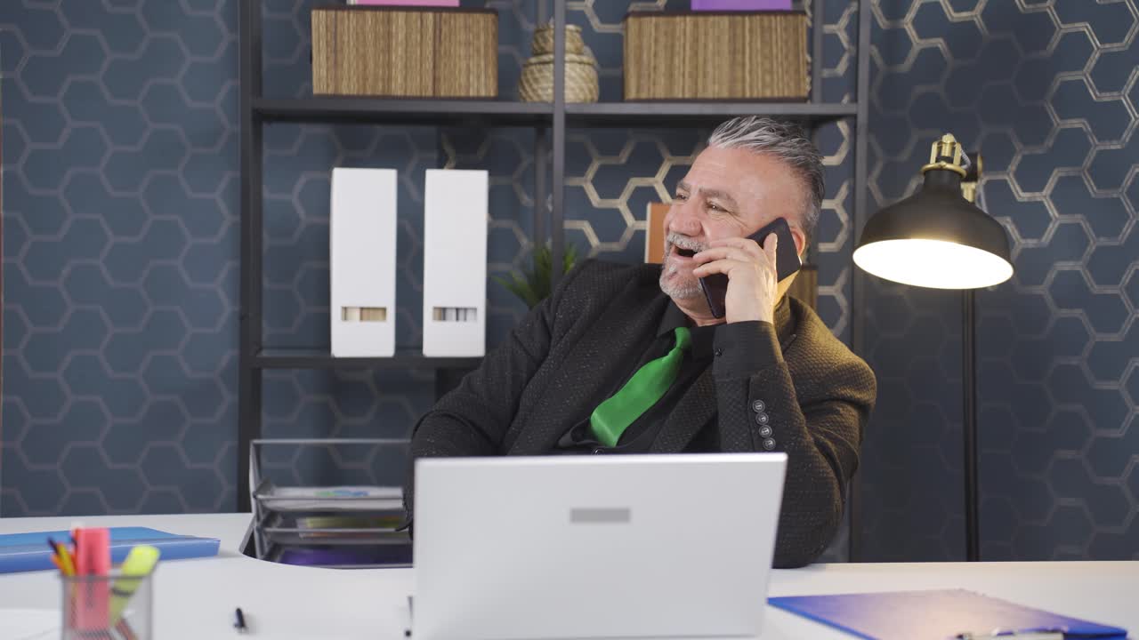 Businessman getting good news on the phone.