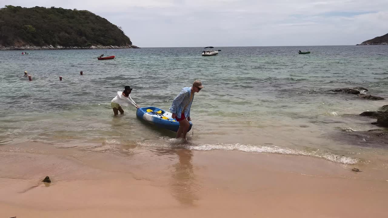 People Kayaking on a Tropical Beach