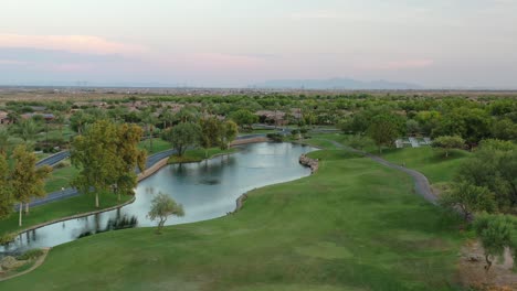 stunning overhead aerial of a beautiful golf course, lake and luxury resort homes