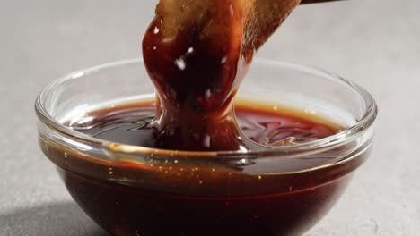 dipping soup dumplings in sauce