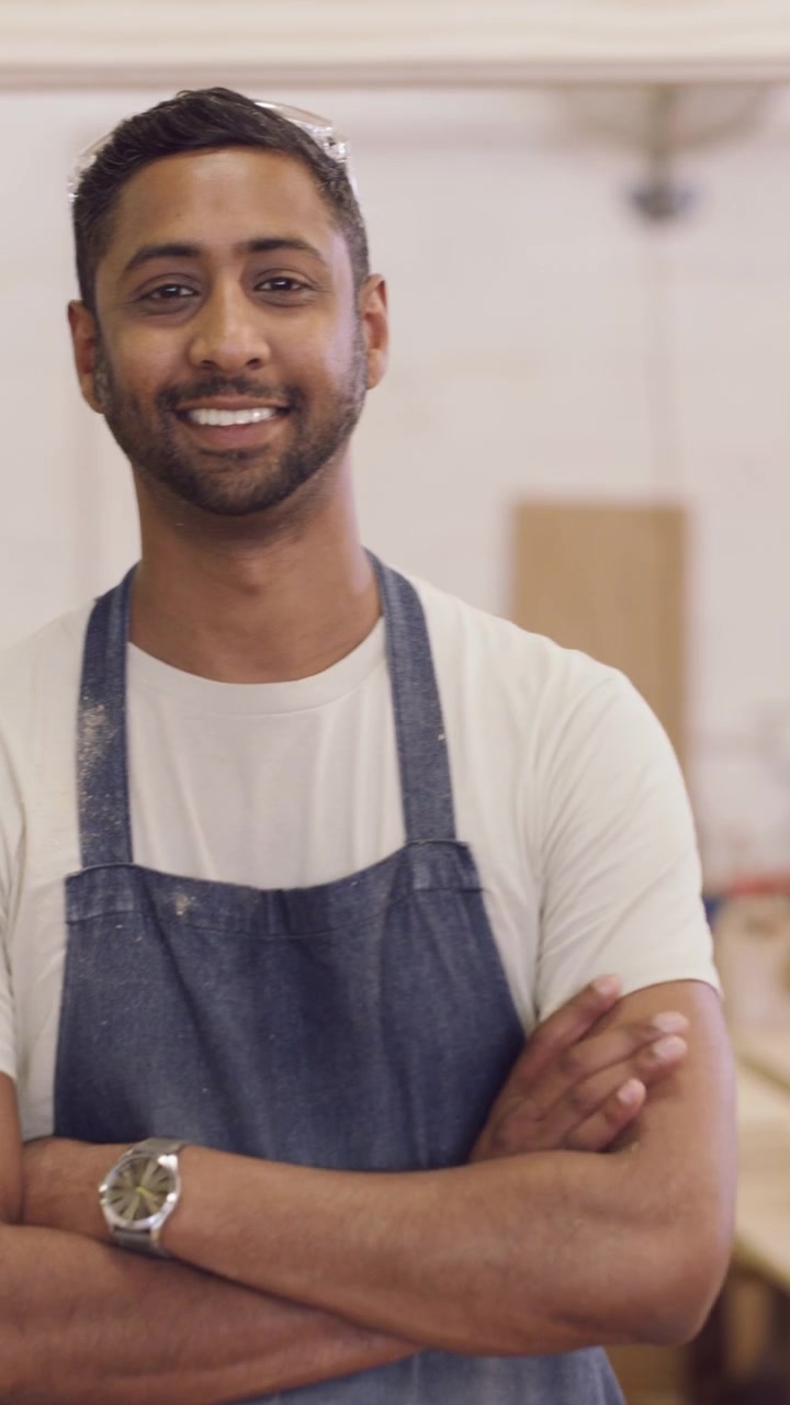 Ritratto di un falegname sorridente in un laboratorio di falegnameria