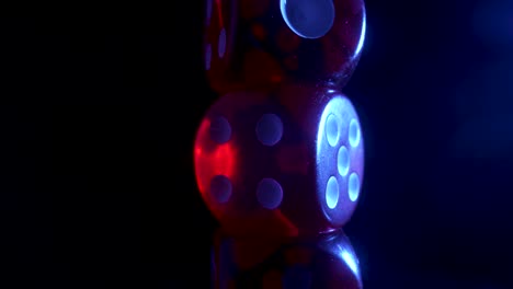 close-up of red dice under colored light