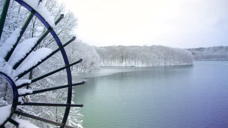 a handheld view of a freshly snow-covered lakeside