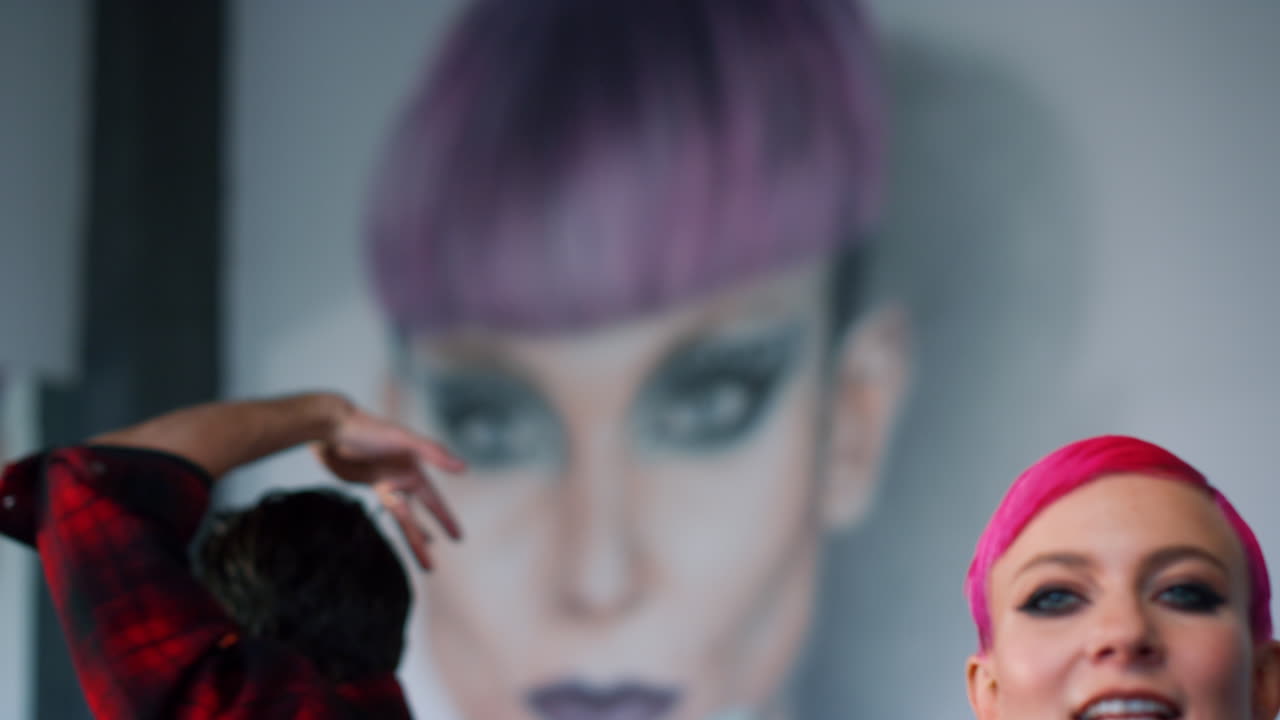 Young couple dancing for camera modern space. Hip hop dancers rehearsing class