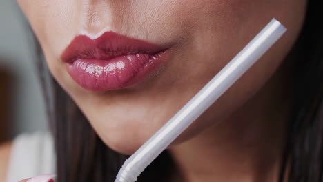 Woman drinking milk with a straw