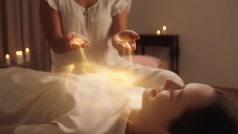 woman receiving energy healing session with golden light