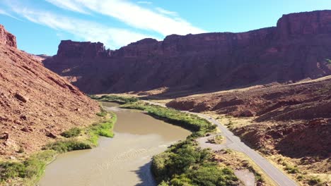 slow aerial flyover of the colorado river in utah adjacent to highway 128 near moab utah with campsites