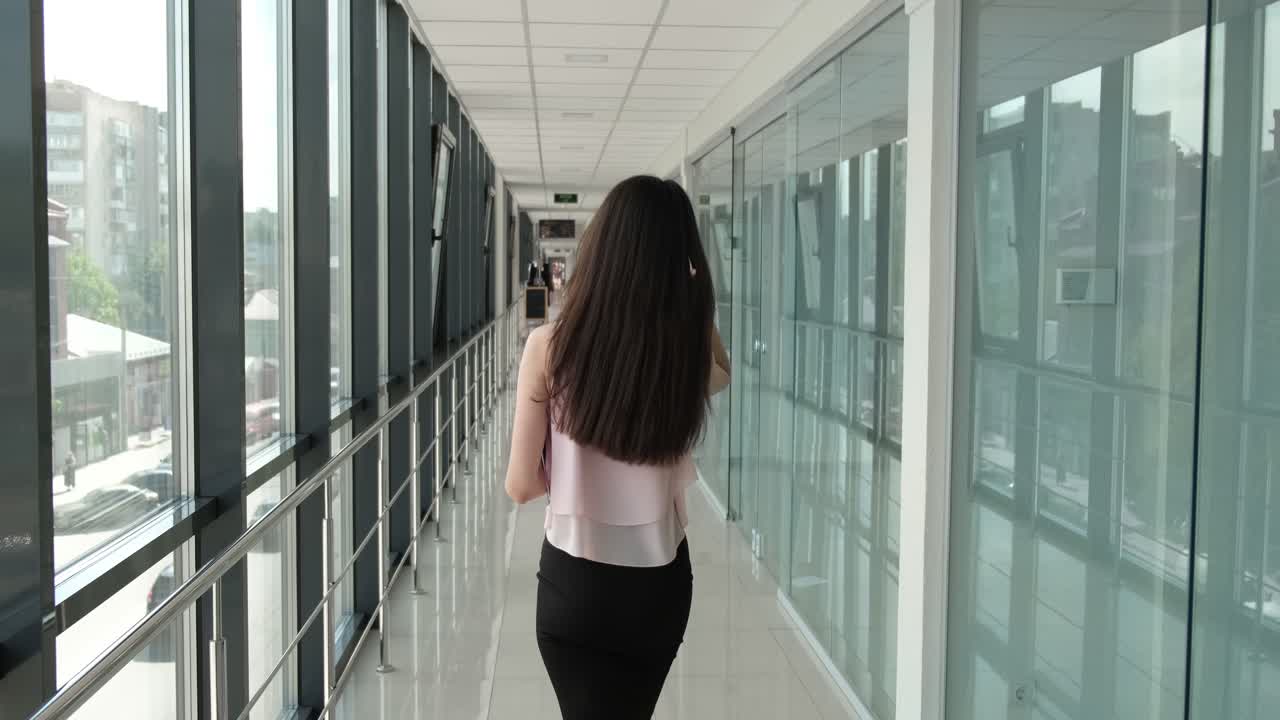 business lady stylishly dressed walks down the hall