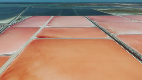 scenic aerial view of albanian sea salt farm shallow solar evaporation ponds