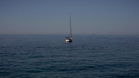 Serene-view-of-a-small-fishing-boat-and-the-movement-of-gentle-waves-at-Camogli-beach,-Italy