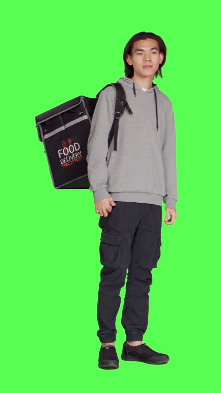Front view of young man works on food delivery