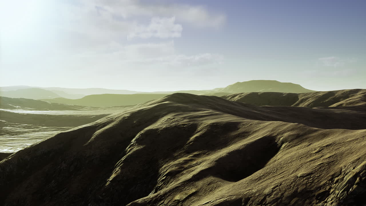 Vast undulating hills under a soft afternoon light in a serene landscape
