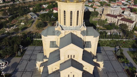 revealing shot of the golden cross and dome roof of the holy trinity church