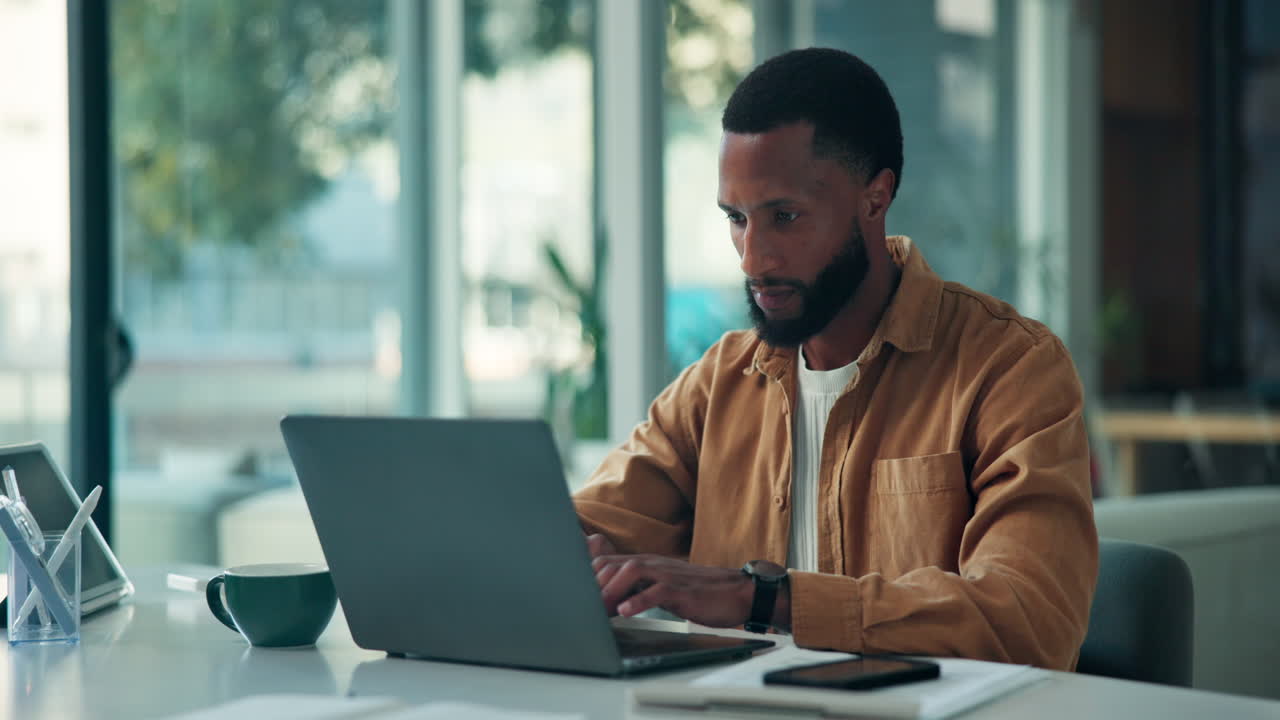 Man Celebrating Success at Laptop