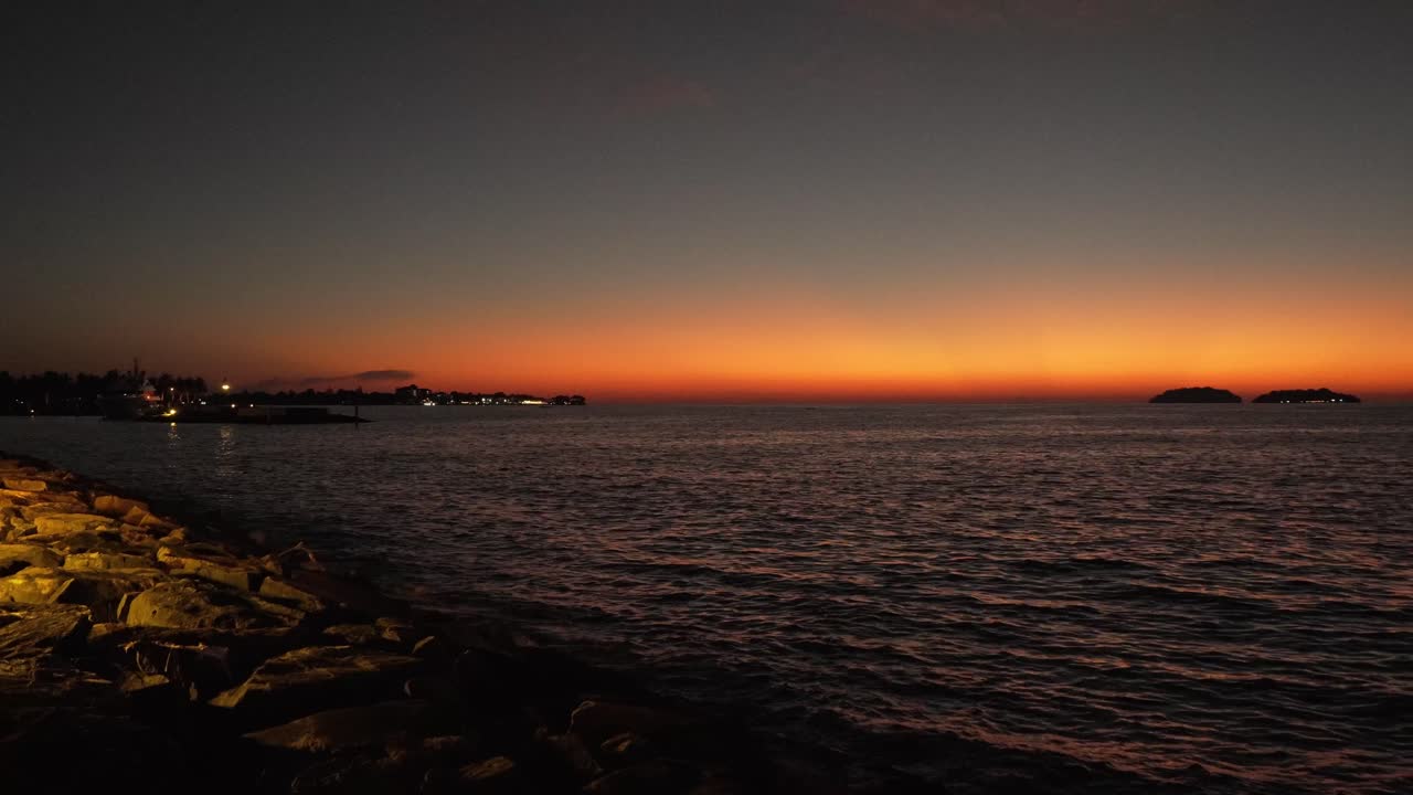 Beautiful stuning sunset,with nice city background,with boat and blue sea
