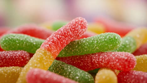 colorful array of sugary candy gummy worms piled together, showcasing a vibrant mix of red, green, and yellow sweet treats full of flavor and fun
