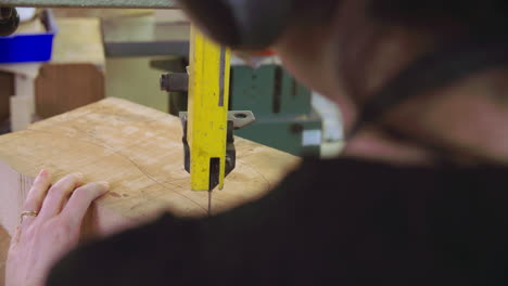 bespoke shoemaker cutting wooden last for shoe using jigsaw