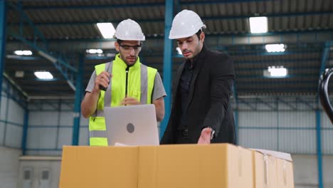 Two-factory-workers-working-and-discussing-manufacturing-plan-in-the-factory-.