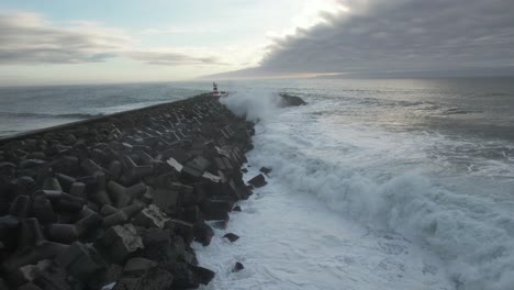 powerful waves crashing on pier