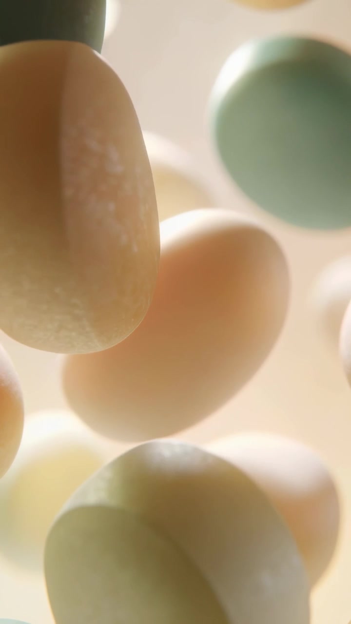 Vertical video: Shifting frame causing beige oval rotating drifting in studio, pastel ovals bokeh