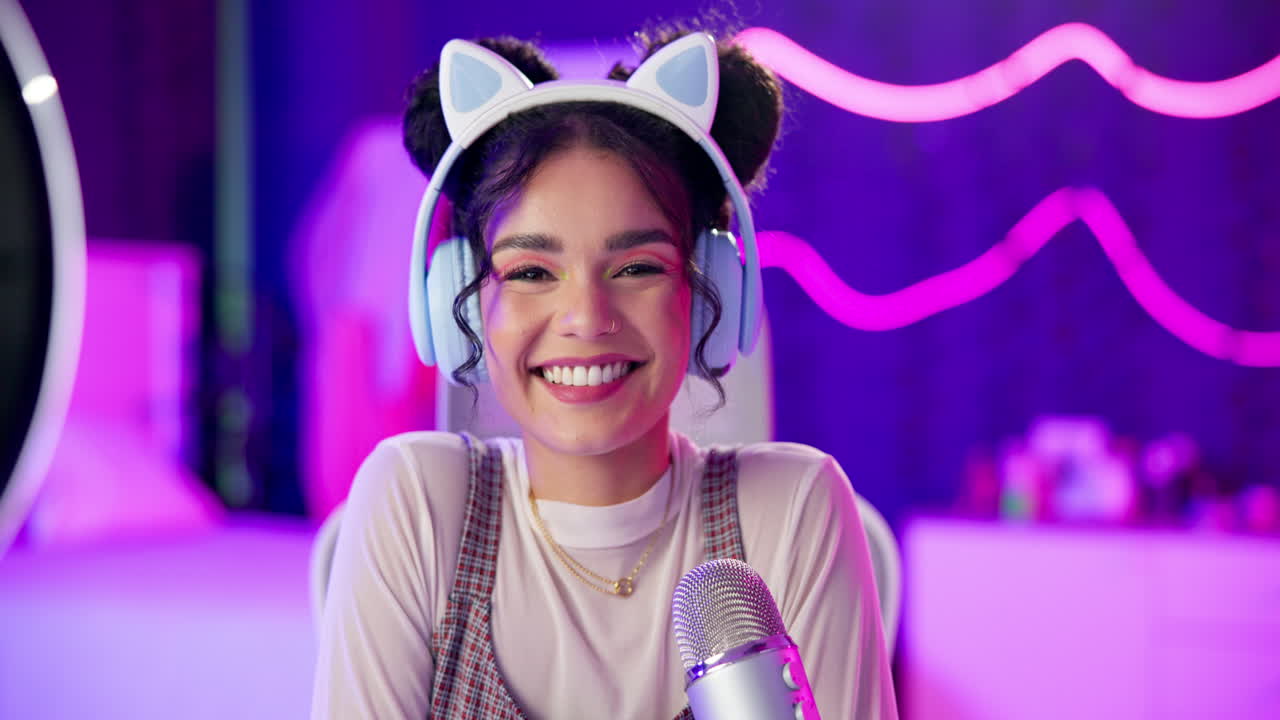 Smiling woman with headphones and microphone in front of neon lights