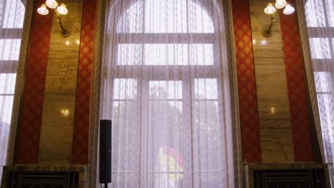 slowly moving towards big window framed by marble wall´s with chandelier´s - wedding room